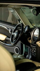 Explore the luxurious interior of a vintage car with a detailed close-up of the dashboard and steering wheel.